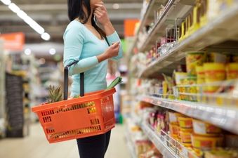 Grocery store aisle with student shopping